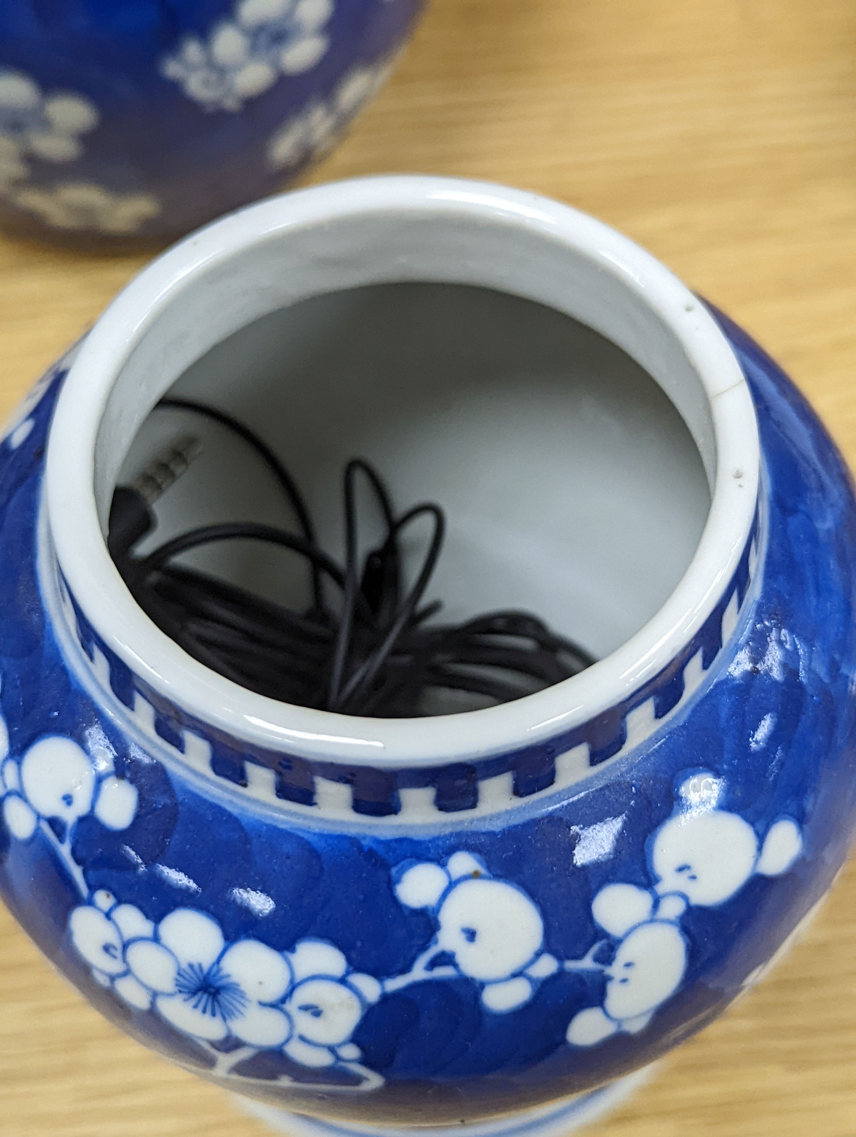 Three Chinese blue and white prunus decorated jars and covers, 19th/20th century, with four character marks 18cm